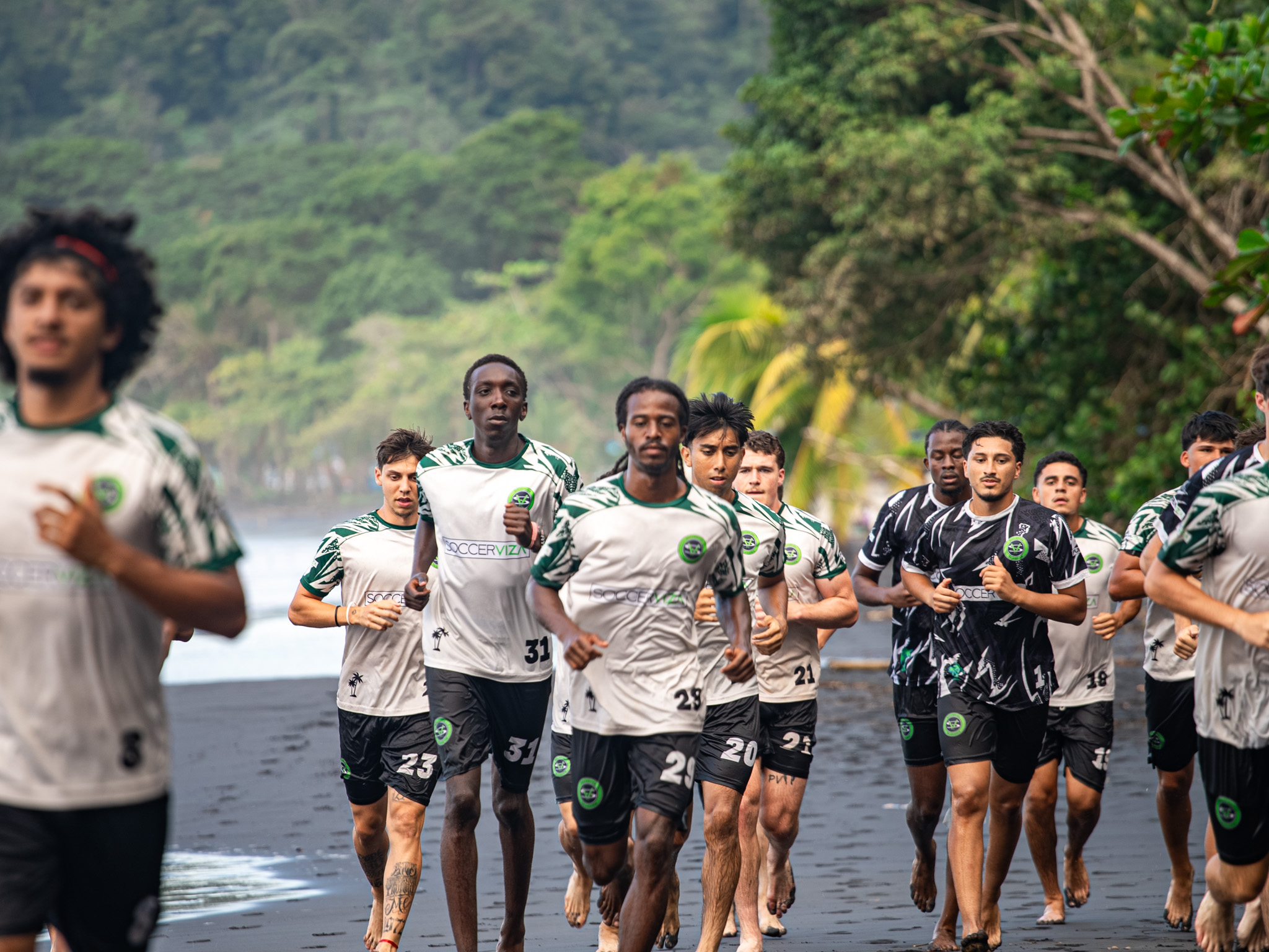 Team stretching on black sand beach